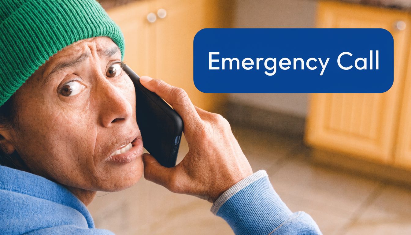 A concerned person wearing a green beanie talking on a mobile phone during an emergency situation.